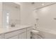 Bathroom features a marble floor, tiled shower over tub and a large mirror at 8866 Waterleaf Ln, Littleton, CO 80125