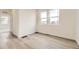 This bedroom has light wood flooring and large windows at 8866 Waterleaf Ln, Littleton, CO 80125