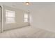 Well-lit bedroom with neutral carpet, two large windows with blinds, and a calming color scheme at 8866 Waterleaf Ln, Littleton, CO 80125