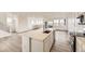 Open kitchen with large center island, stainless steel appliances, and ample natural light at 8866 Waterleaf Ln, Littleton, CO 80125