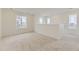 A spacious living room has multiple windows and neutral carpet at 8866 Waterleaf Ln, Littleton, CO 80125