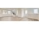 Bright and spacious living room featuring wood floors, staircase, and large windows at 8866 Waterleaf Ln, Littleton, CO 80125