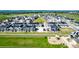 Aerial view of modern community featuring solar panels, landscaped yards, and central green space at 1500 Sun Way, Lafayette, CO 80026