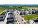 Aerial view showcasing modern community with solar panels, central park, and scenic mountain backdrop at 1500 Sun Way, Lafayette, CO 80026