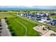 Aerial view of community with playground and walking path surrounded by lush green space at 1500 Sun Way, Lafayette, CO 80026
