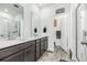 Modern bathroom with double sink vanity, large mirrors, and glass-enclosed shower at 1500 Sun Way, Lafayette, CO 80026