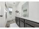 Bathroom featuring a long vanity with stylish fixtures, art, and a window at 1500 Sun Way, Lafayette, CO 80026