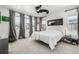 Bright bedroom with large windows, gray curtains, and a unique ceiling fan at 1500 Sun Way, Lafayette, CO 80026