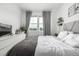 Bedroom featuring modern decor, neutral colors, and natural light from the large window at 1500 Sun Way, Lafayette, CO 80026