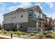 Two-story home showcasing two-tone siding, solar panels, manicured landscaping and a charming front porch at 1500 Sun Way, Lafayette, CO 80026