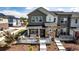 Inviting townhome featuring a front porch seating area and beautifully landscaped front yard at 1500 Sun Way, Lafayette, CO 80026