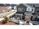 A charming townhouse with a stone-accented porch provides a welcoming outdoor seating area at 1500 Sun Way, Lafayette, CO 80026