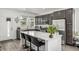 Modern kitchen with a large island, stainless steel appliances, and gray cabinets at 1500 Sun Way, Lafayette, CO 80026