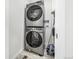 Laundry room featuring stacked washer and dryer and tile flooring at 1500 Sun Way, Lafayette, CO 80026