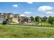 Neighborhood playground surrounded by colorful homes and lush green grass on a sunny day at 1500 Sun Way, Lafayette, CO 80026