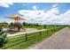 Community playground with slides and play area on a sunny day with a walking path nearby at 1500 Sun Way, Lafayette, CO 80026