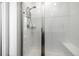 Clean and bright shower with white tiles, glass door, and built-in bench at 1500 Sun Way, Lafayette, CO 80026