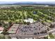 Aerial view showcases a community center, swimming pool, tennis courts, and ample parking at 3889 S Fraser St, Aurora, CO 80014