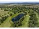 Aerial view of a golf course community with ponds, fairways, and lush greenery at 3889 S Fraser St, Aurora, CO 80014