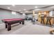 Finished basement with a pool table, bar area, and workout equipment, perfect for entertaining and fitness at 3889 S Fraser St, Aurora, CO 80014