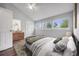 Bright bedroom featuring vaulted ceilings, three windows, and a comfortable bed with stylish bedding at 3889 S Fraser St, Aurora, CO 80014