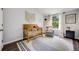 Charming Bedroom with a wooden crib, a cozy armchair, and natural light from a large window at 3889 S Fraser St, Aurora, CO 80014