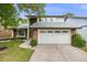 Charming home featuring a two-car garage, brick accents, and a well-maintained front yard at 3889 S Fraser St, Aurora, CO 80014