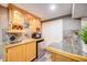 Convenient kitchenette with granite countertops, wooden cabinets, and modern appliances at 3889 S Fraser St, Aurora, CO 80014