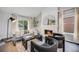 Inviting living room featuring a fireplace, large windows, and stylish modern furniture at 3889 S Fraser St, Aurora, CO 80014