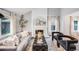 Bright living room with a cozy fireplace, elegant decor, and plenty of natural light at 3889 S Fraser St, Aurora, CO 80014