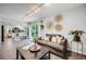 Bright living room featuring a cozy sofa and an open floor plan to the adjacent, modern kitchen at 3889 S Fraser St, Aurora, CO 80014
