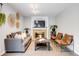 Comfortable living room featuring a brick fireplace, stylish seating, and neutral decor at 3889 S Fraser St, Aurora, CO 80014