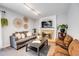 Relaxing living room featuring modern decor, comfortable seating, and a cozy fireplace at 3889 S Fraser St, Aurora, CO 80014
