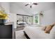 Spacious bedroom with large mirror closet doors, plush carpet, and a ceiling fan for added comfort at 3889 S Fraser St, Aurora, CO 80014