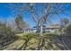 Spacious backyard with lush greenery, mature trees, and a view of the home's exterior at 4401 S Yosemite Ct, Greenwood Village, CO 80111