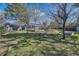 Large backyard featuring mature trees, a well-maintained lawn, and outdoor seating areas at 4401 S Yosemite Ct, Greenwood Village, CO 80111