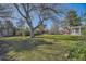 Expansive backyard with lush green lawn and mature trees, creating a serene outdoor space at 4401 S Yosemite Ct, Greenwood Village, CO 80111