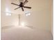 Unfinished basement featuring carpet, drop ceiling, and small egress windows at 4401 S Yosemite Ct, Greenwood Village, CO 80111