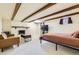 Finished basement featuring a fireplace, exposed wood ceiling beams, and a TV at 4401 S Yosemite Ct, Greenwood Village, CO 80111