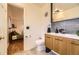 Modern bathroom with a wood vanity, gray tile backsplash, and a view into the bedroom at 4401 S Yosemite Ct, Greenwood Village, CO 80111