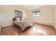Bedroom with two windows, wood-look floors, and neutral decor at 4401 S Yosemite Ct, Greenwood Village, CO 80111