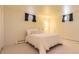 Bedroom with white carpet and a white comforter, featuring two egress windows at 4401 S Yosemite Ct, Greenwood Village, CO 80111