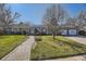 Charming home with walkway, lush lawn and mature trees, providing great curb appeal and a welcoming entrance at 4401 S Yosemite Ct, Greenwood Village, CO 80111