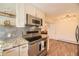 Kitchen features stainless steel appliances, granite countertops, and access to the living room at 4401 S Yosemite Ct, Greenwood Village, CO 80111