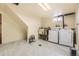 This laundry room has a utility sink, washer, dryer, and modern tile flooring at 4401 S Yosemite Ct, Greenwood Village, CO 80111