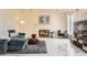 Comfortable living room featuring a fireplace, stylish furniture, and bright white marble flooring at 4401 S Yosemite Ct, Greenwood Village, CO 80111