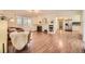 Open-concept living room with fireplace, built-in shelving and access to kitchen at 4401 S Yosemite Ct, Greenwood Village, CO 80111