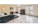 Spacious living room featuring a cozy fireplace, plush seating, marble floors and natural light at 4401 S Yosemite Ct, Greenwood Village, CO 80111