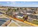 Aerial view of home in a tree-filled neighborhood and fenced yard at 13586 W Warren Cir, Lakewood, CO 80228