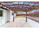 Covered back patio features decorative lighting and access to the backyard at 13586 W Warren Cir, Lakewood, CO 80228